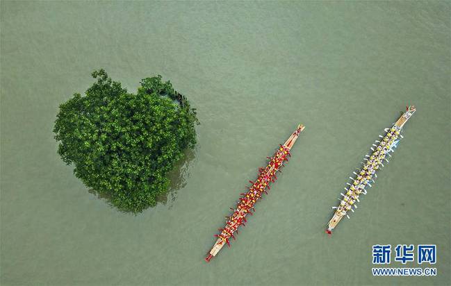 6月14日，两艘龙舟行驶在浙江省温州市南塘老街附近一处水域（无人机拍摄）。 端午节将至，各地举行赛龙舟活动喜迎佳节。 新华社发（苏巧将摄）